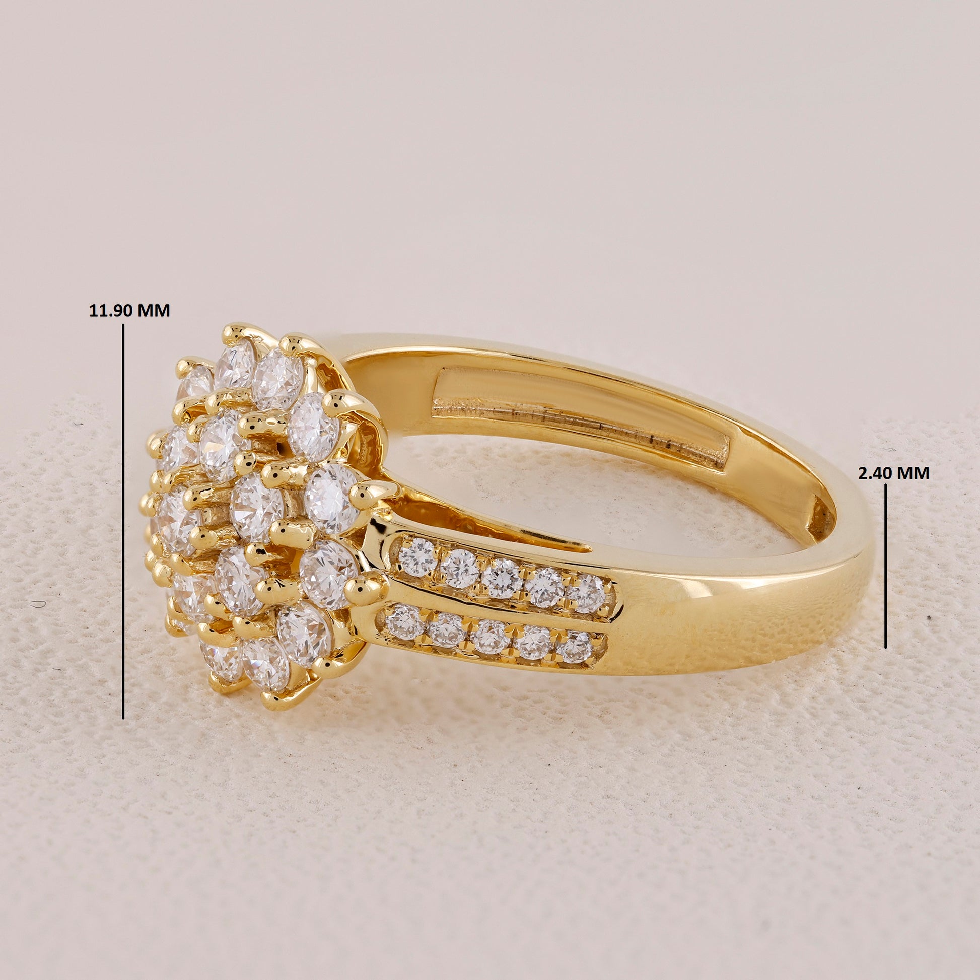 Gold ring with diamond cluster on a light gray background