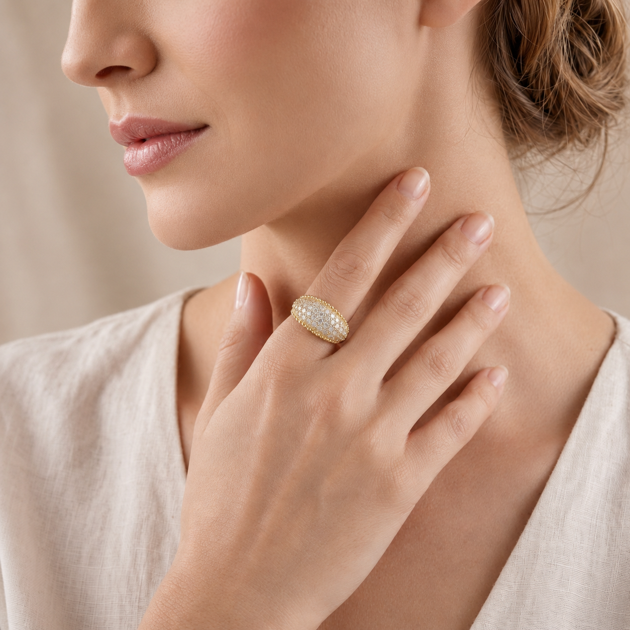 Close-up of a woman wearing a gold ring with a diamond on her hand, touching her neck.