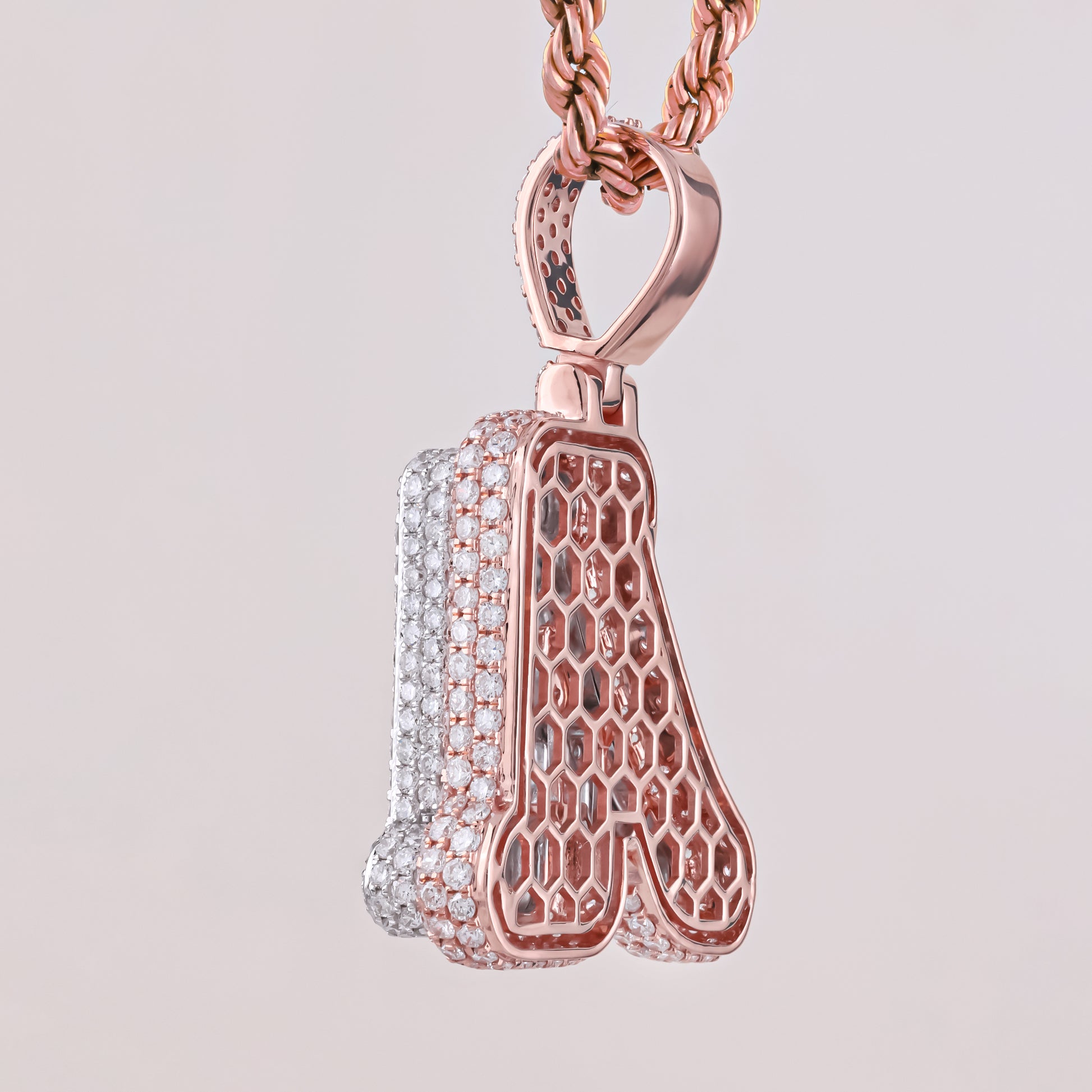 Rose gold and silver pendant on a light gray background