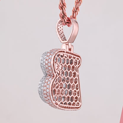 Rose gold and silver honeycomb pendant on a light gray background
