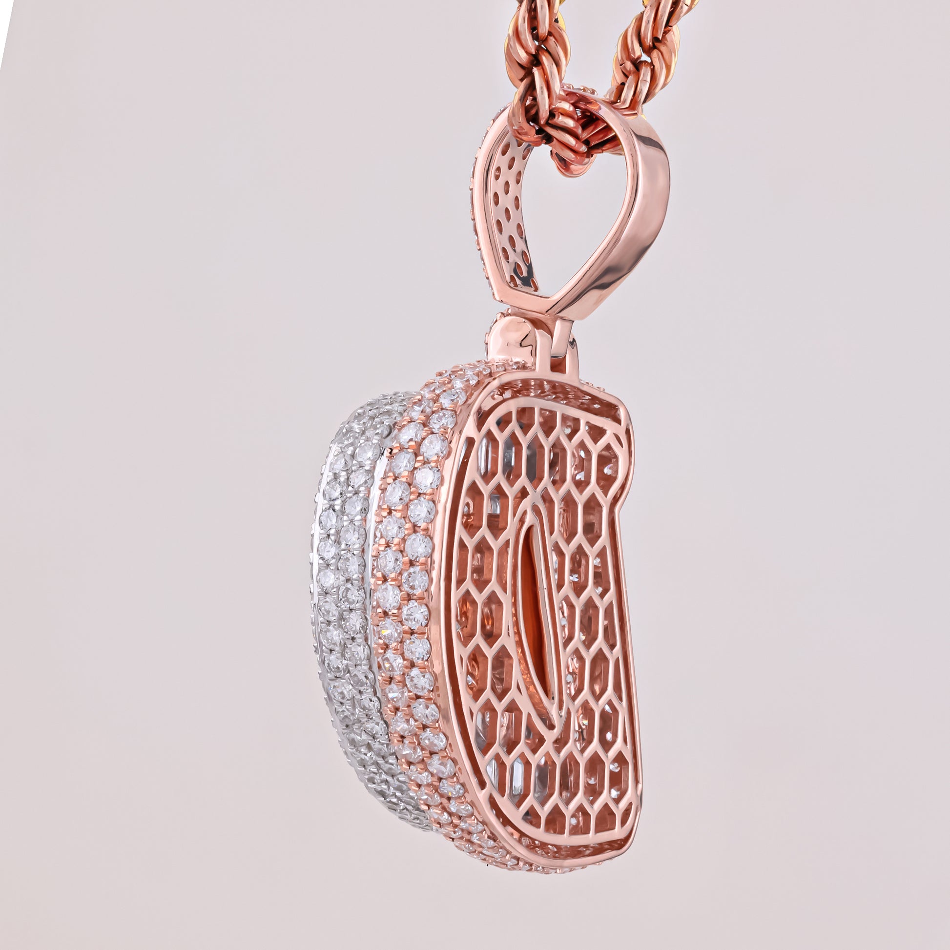 Rose gold and silver pendant on a light gray background