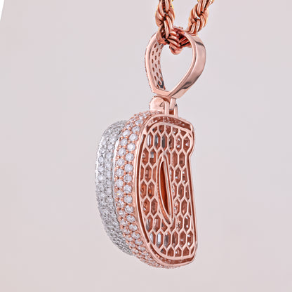 Rose gold and silver pendant on a light gray background