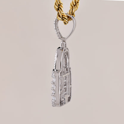 Silver pendant on a gold chain against a beige background