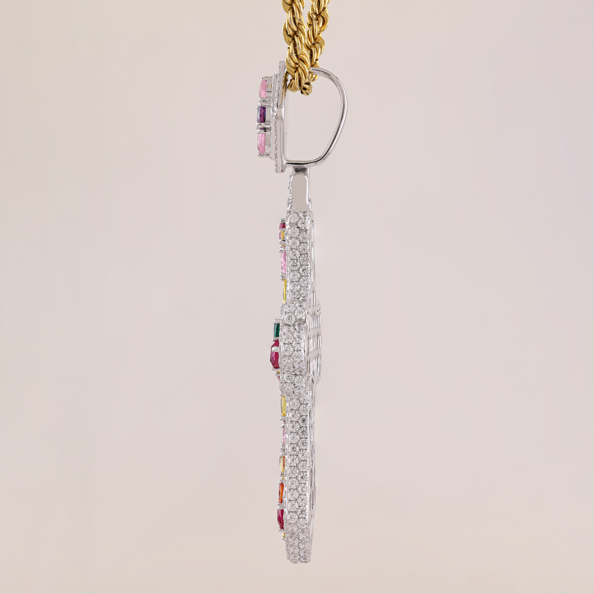 Dangling earring with gemstones on a beige background