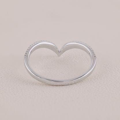 Silver heart-shaped ring on a beige background