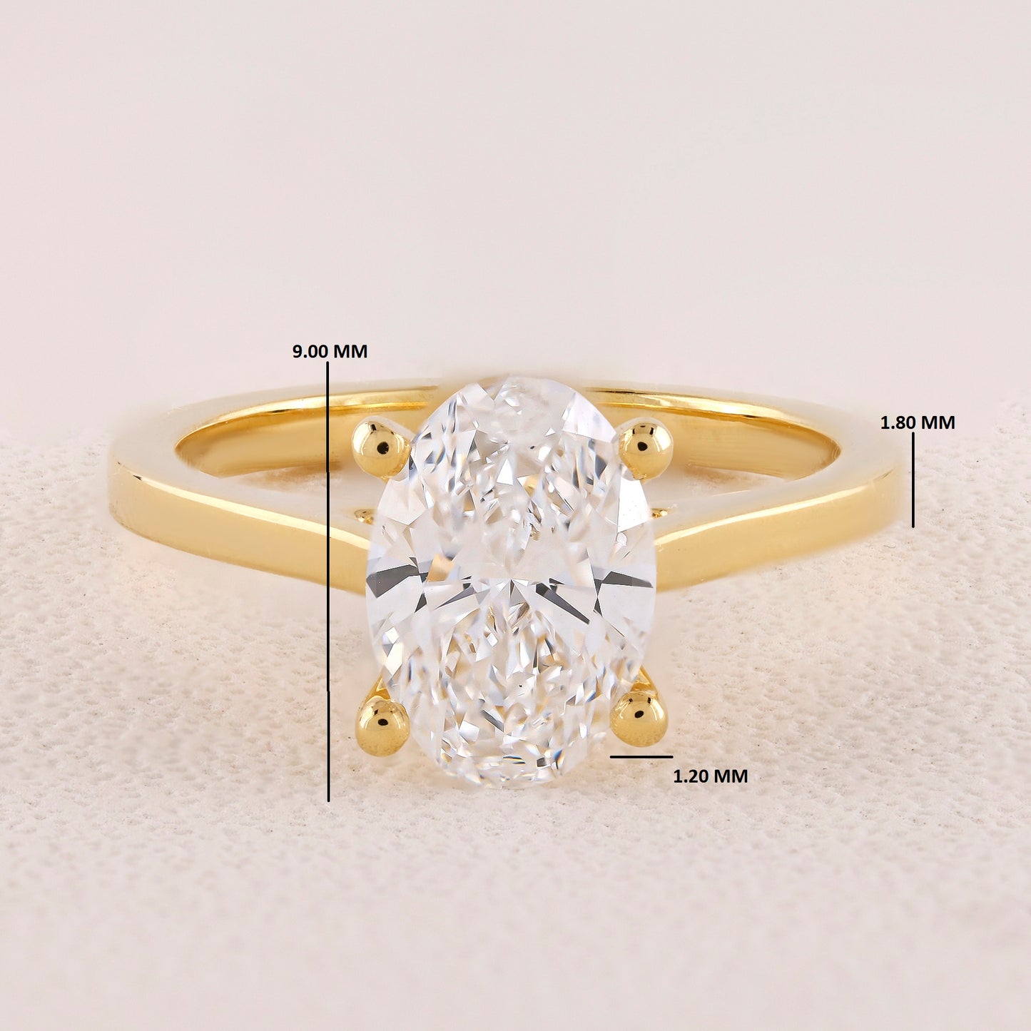 Gold ring with a diamond, showing measurements on a light background