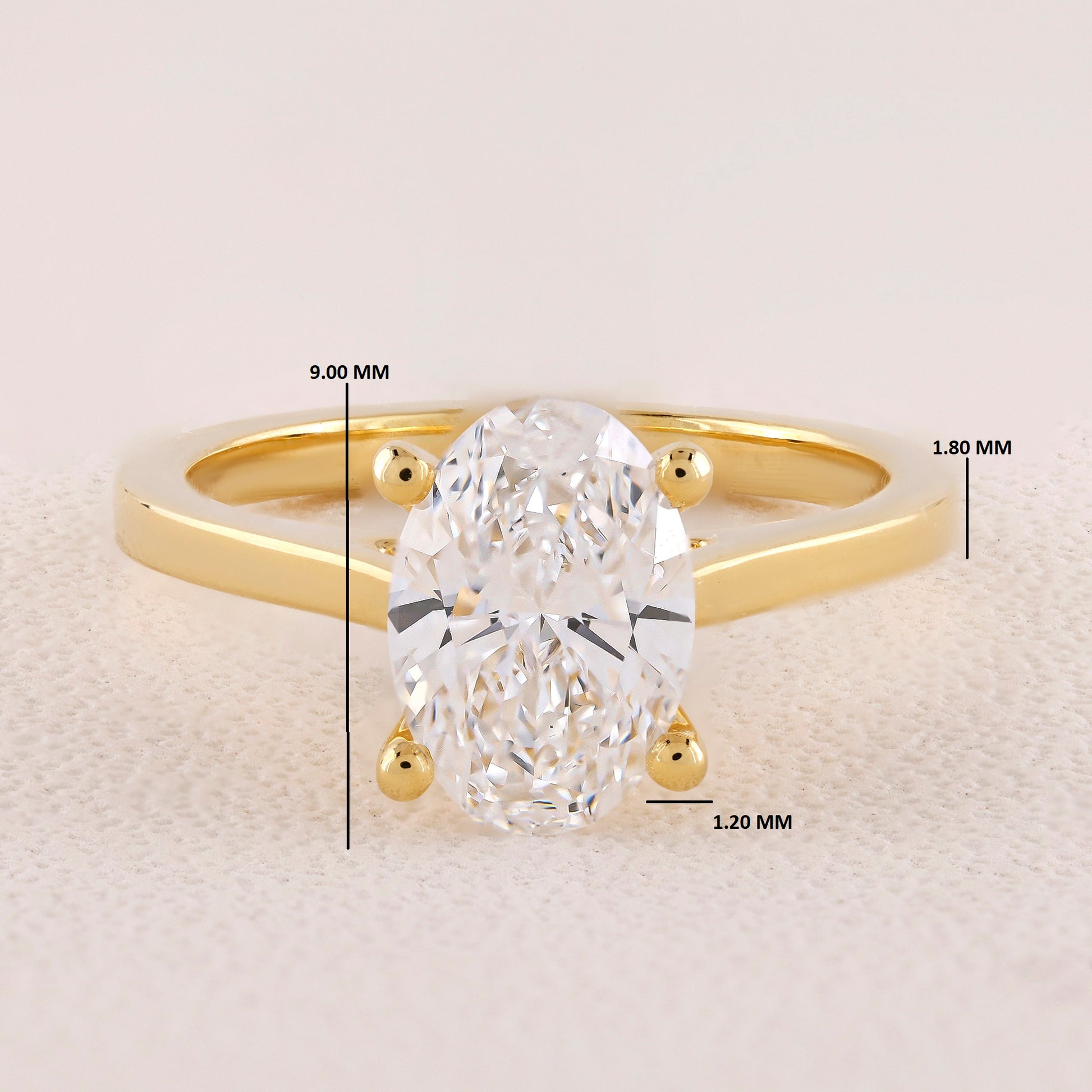 Gold ring with a diamond, showing measurements on a light background