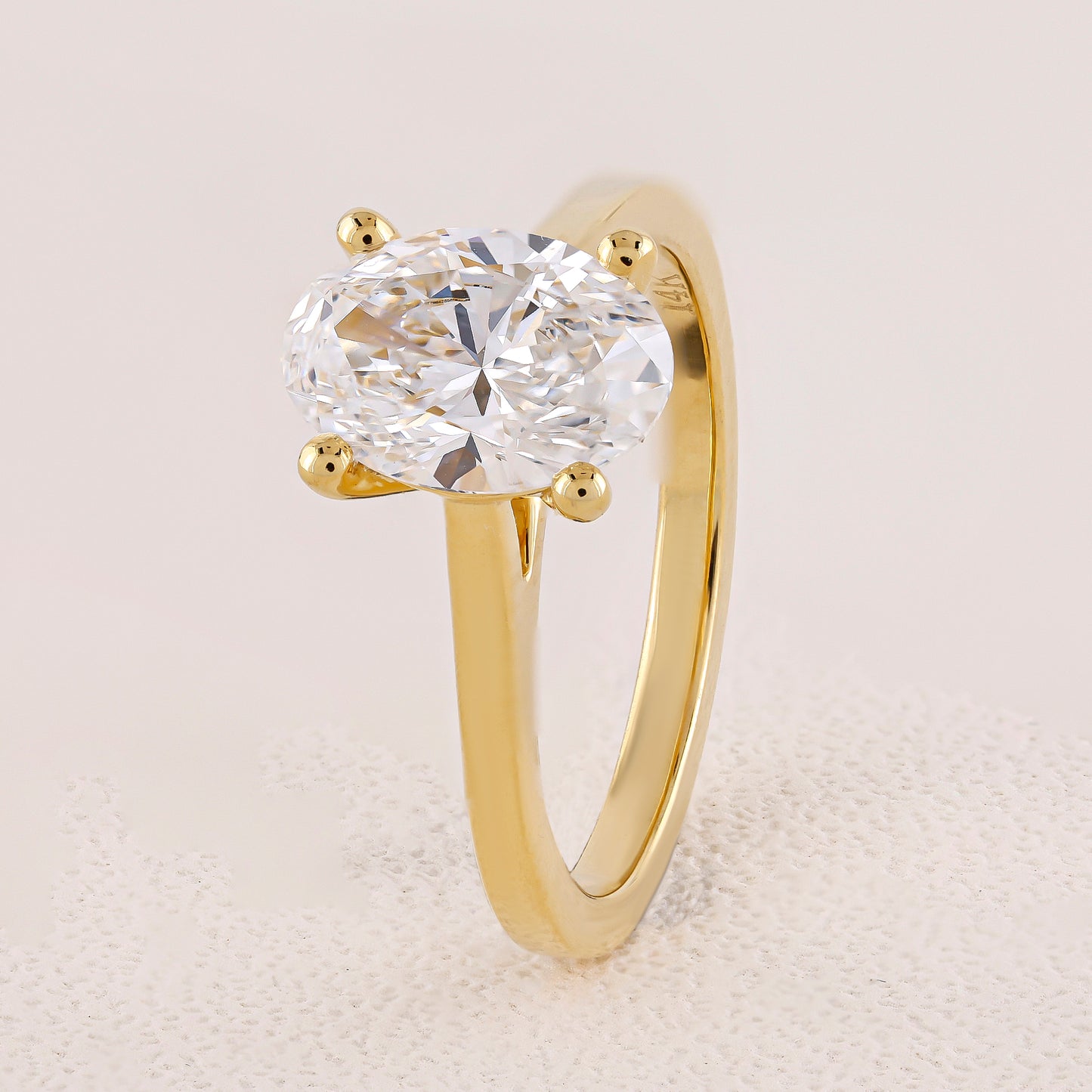 Gold ring with a large diamond on a light background