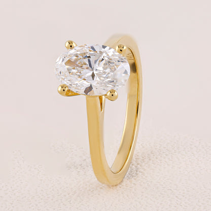 Gold ring with a large diamond on a light background