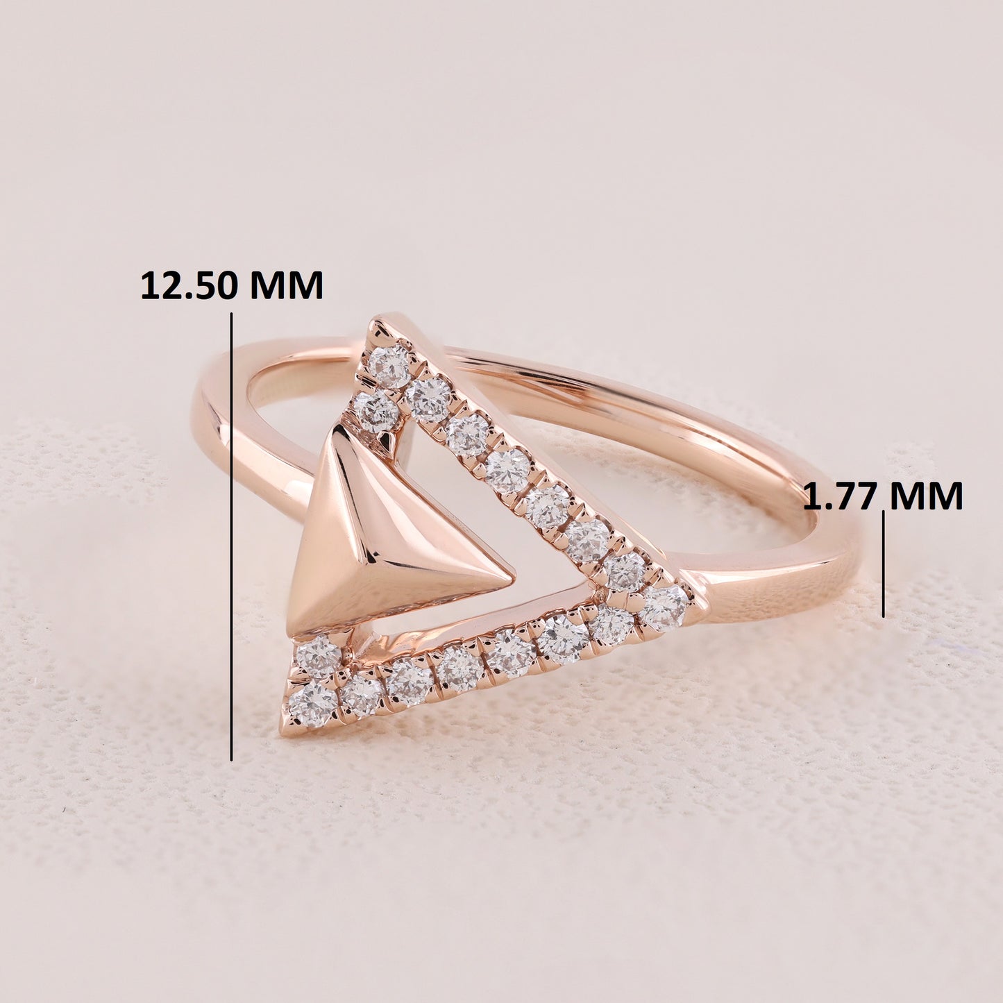 Rose gold ring with diamond accents and measurements on a light background