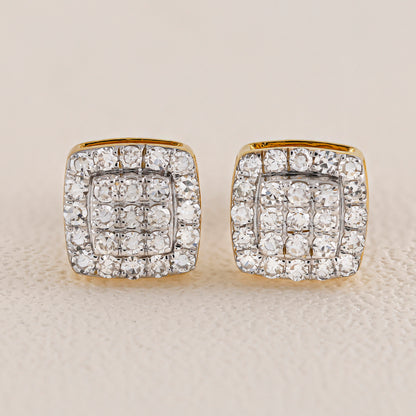 Pair of diamond earrings on a beige background