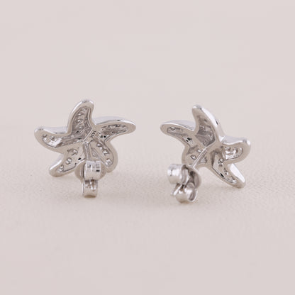 Butterfly-shaped silver earrings on a light gray background