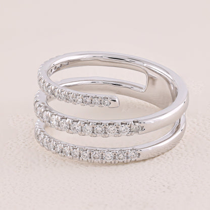 Silver ring with diamond accents on a light beige background
