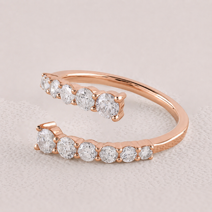 Rose gold ring with clear gemstones on a light gray background