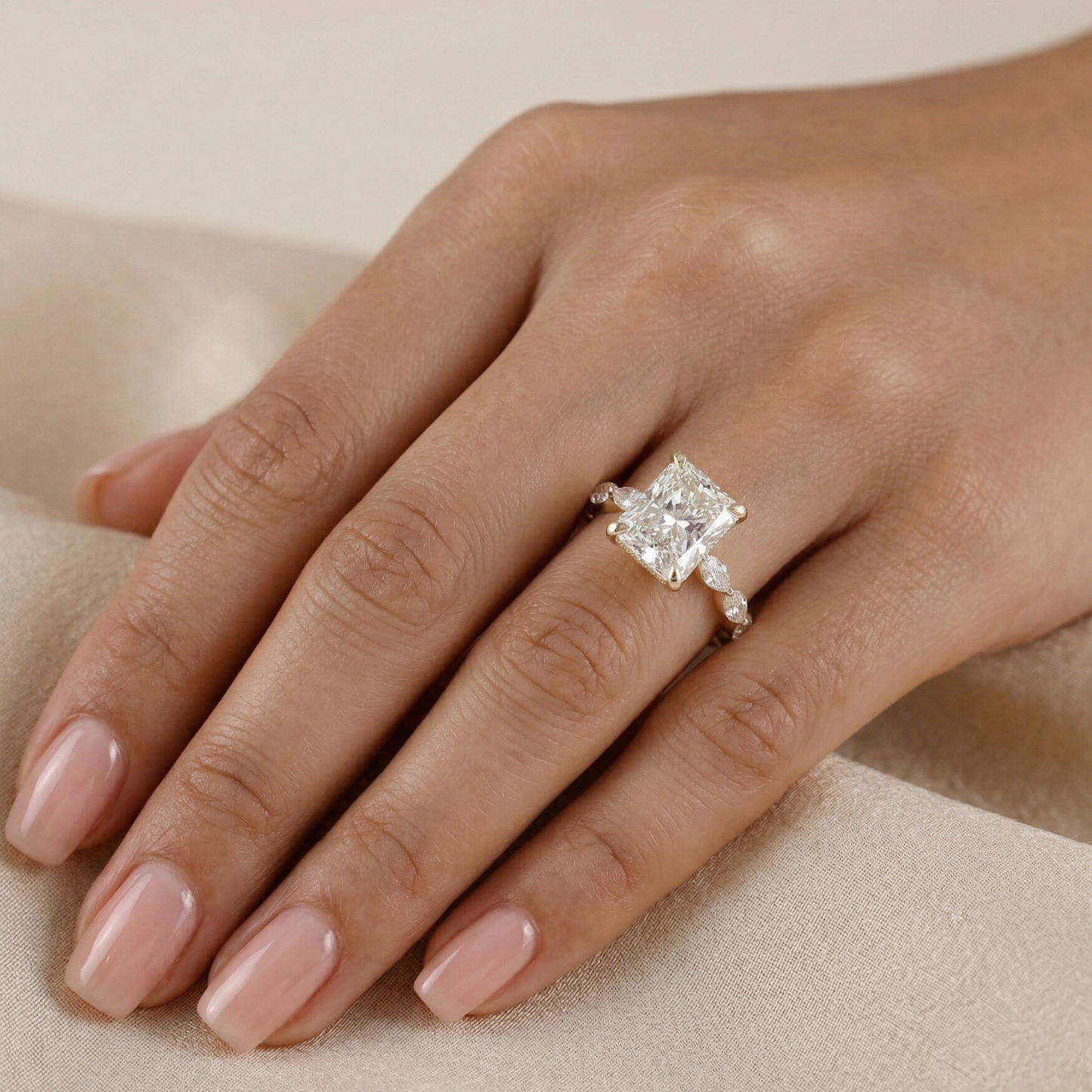 Diamond ring on a hand with a neutral background
