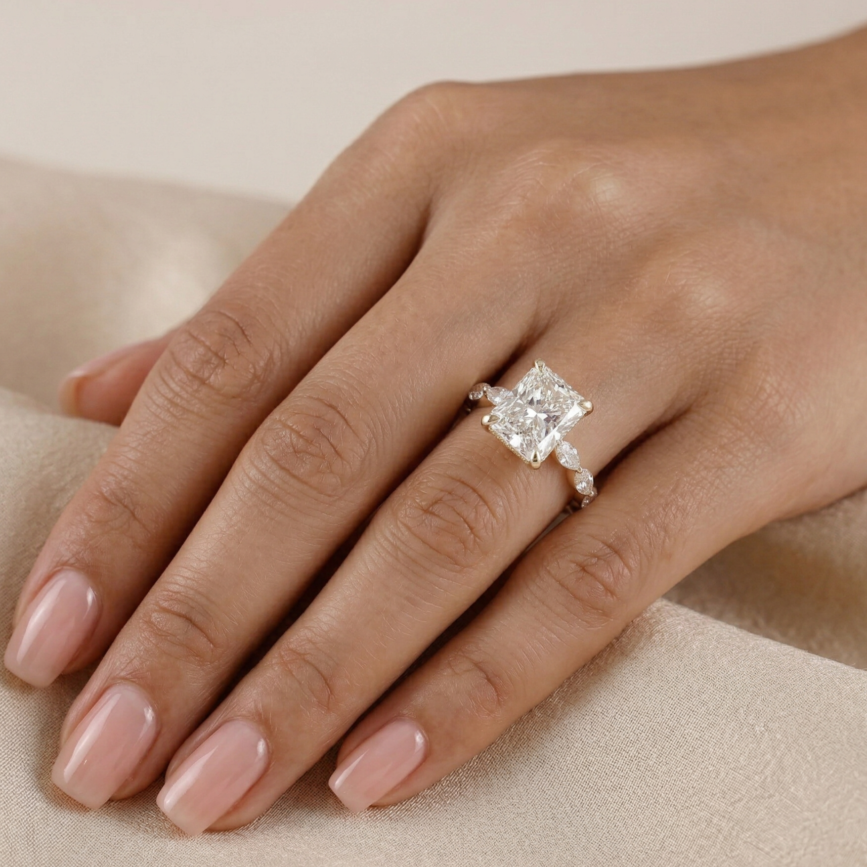 Diamond ring on a hand with a neutral background