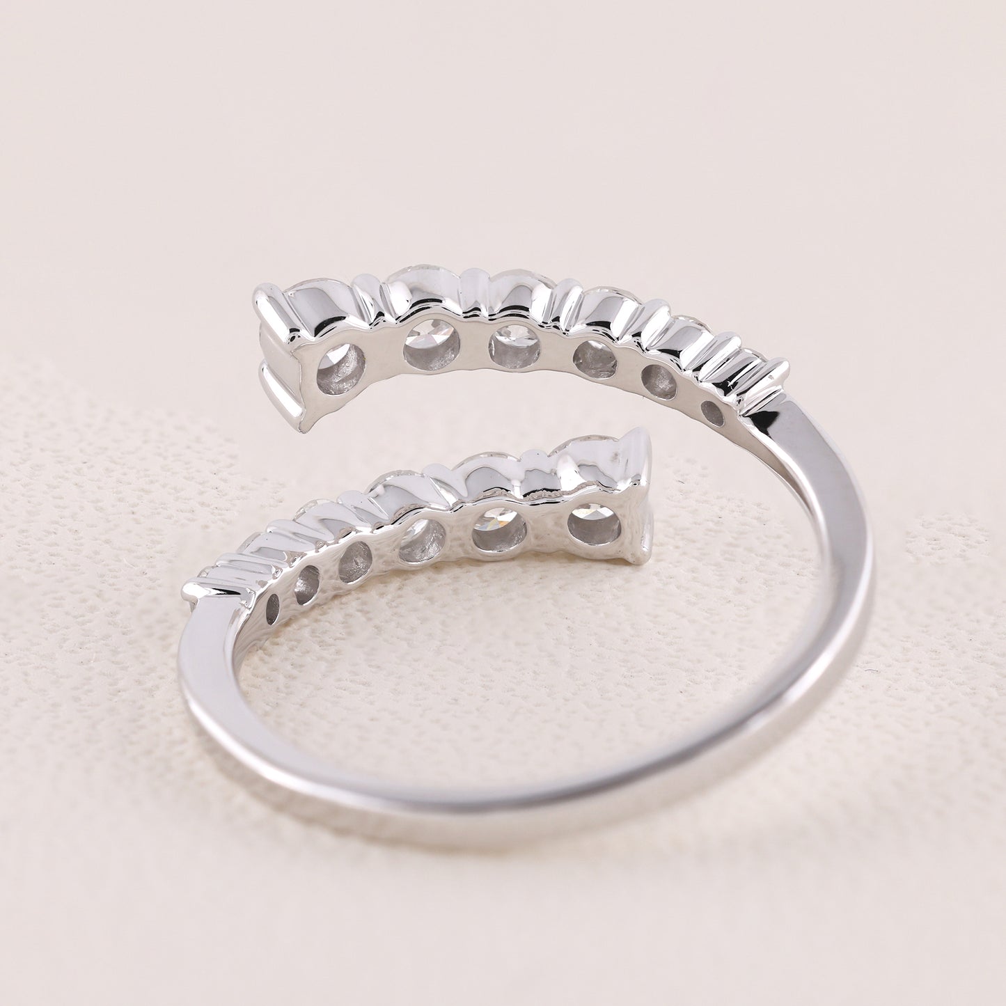 Silver ring with a unique design on a light beige background