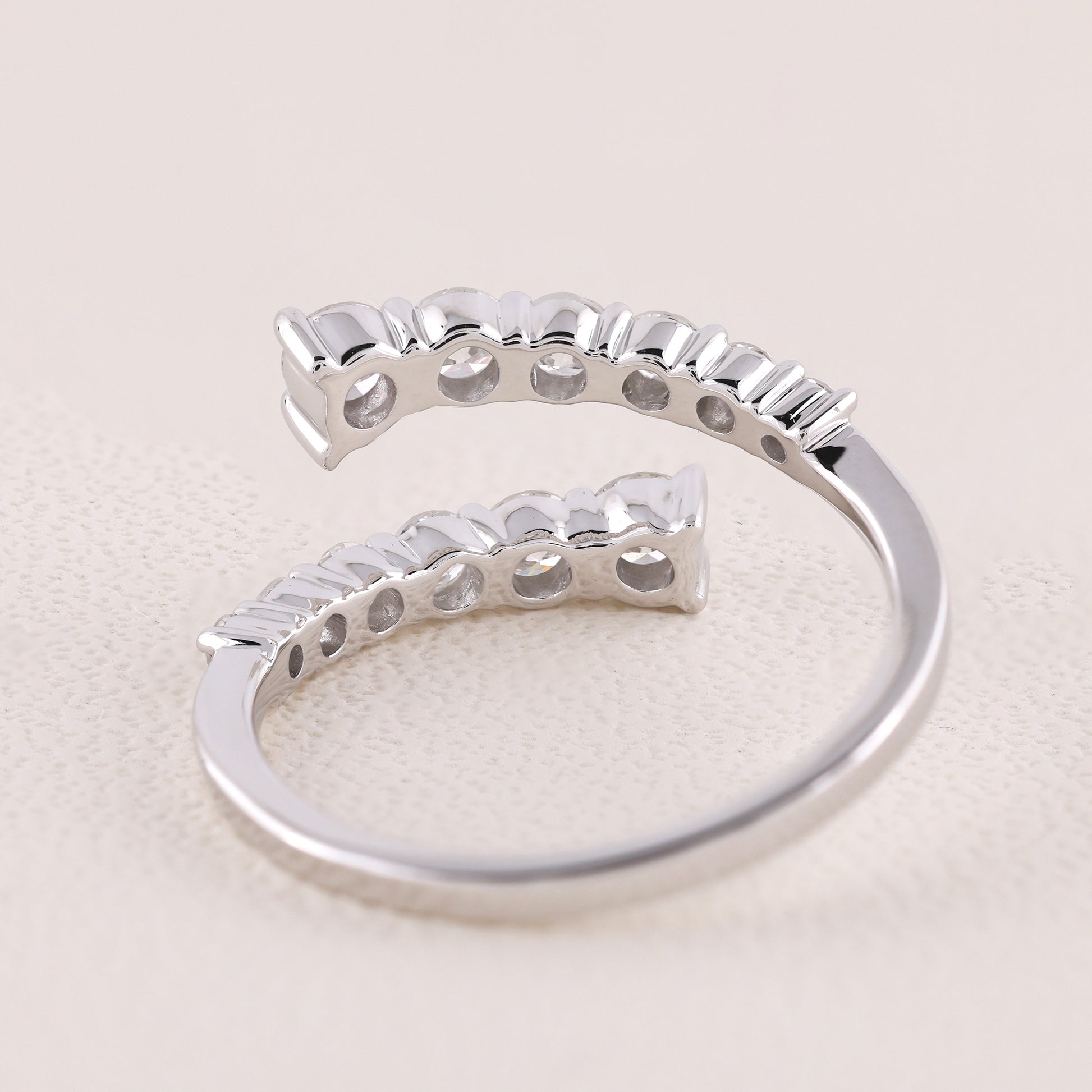 Silver ring with a unique design on a light beige background