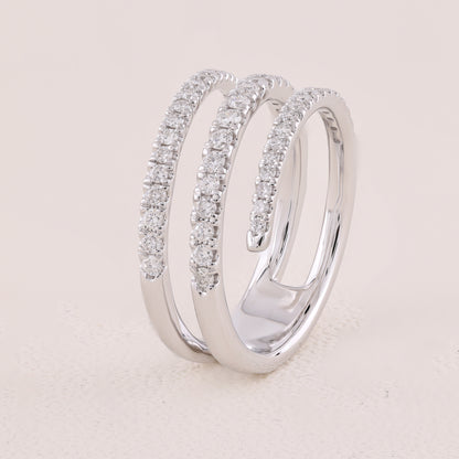 Silver ring with diamond accents on a light beige background