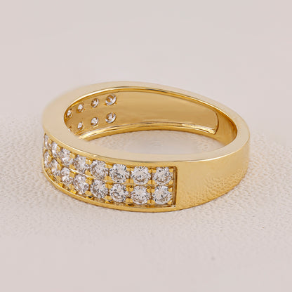 Gold ring with diamond accents on a beige background