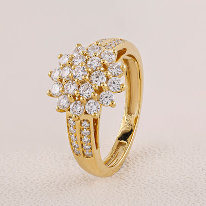 Gold ring with diamond cluster on a light gray background