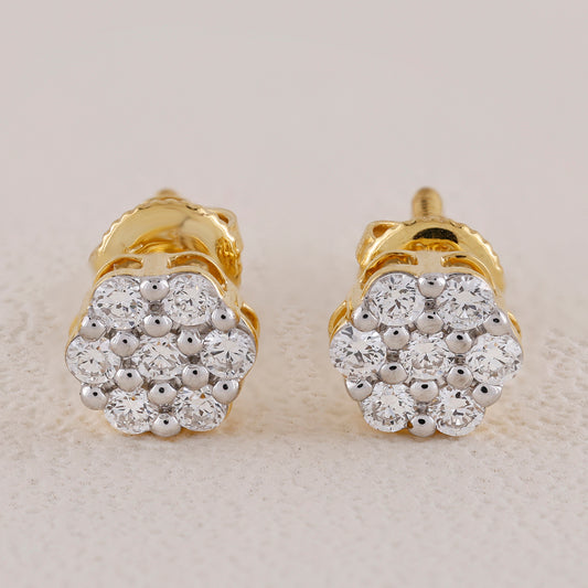 Pair of gold and diamond earrings on a light background