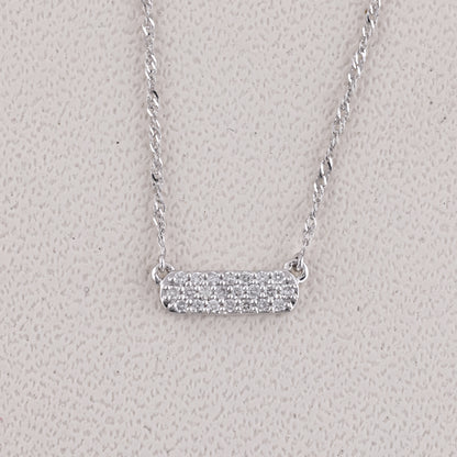 Silver necklace with a bar pendant on a light gray background