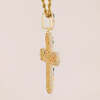 Gold cross pendant with intricate designs on a beige background