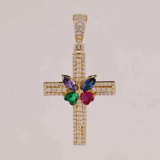 Gold cross pendant with colorful gemstones on a beige background