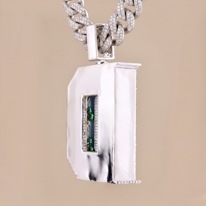 Silver necklace with a rectangular pendant featuring green gemstones on a beige background