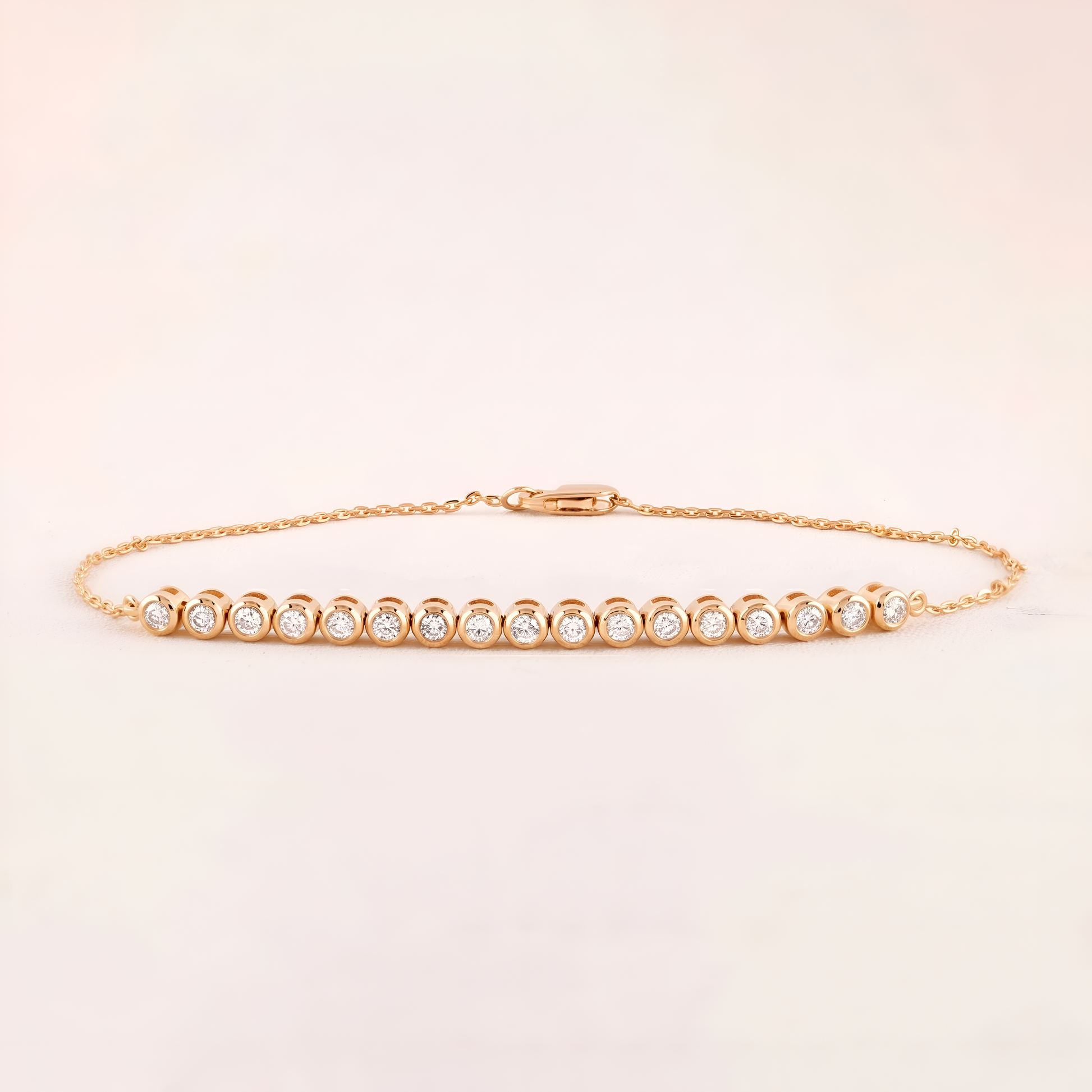 Gold bracelet with small diamonds on a light beige background
