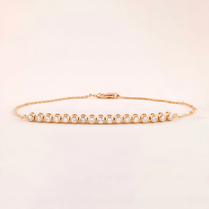 Gold bracelet with small diamonds on a light beige background