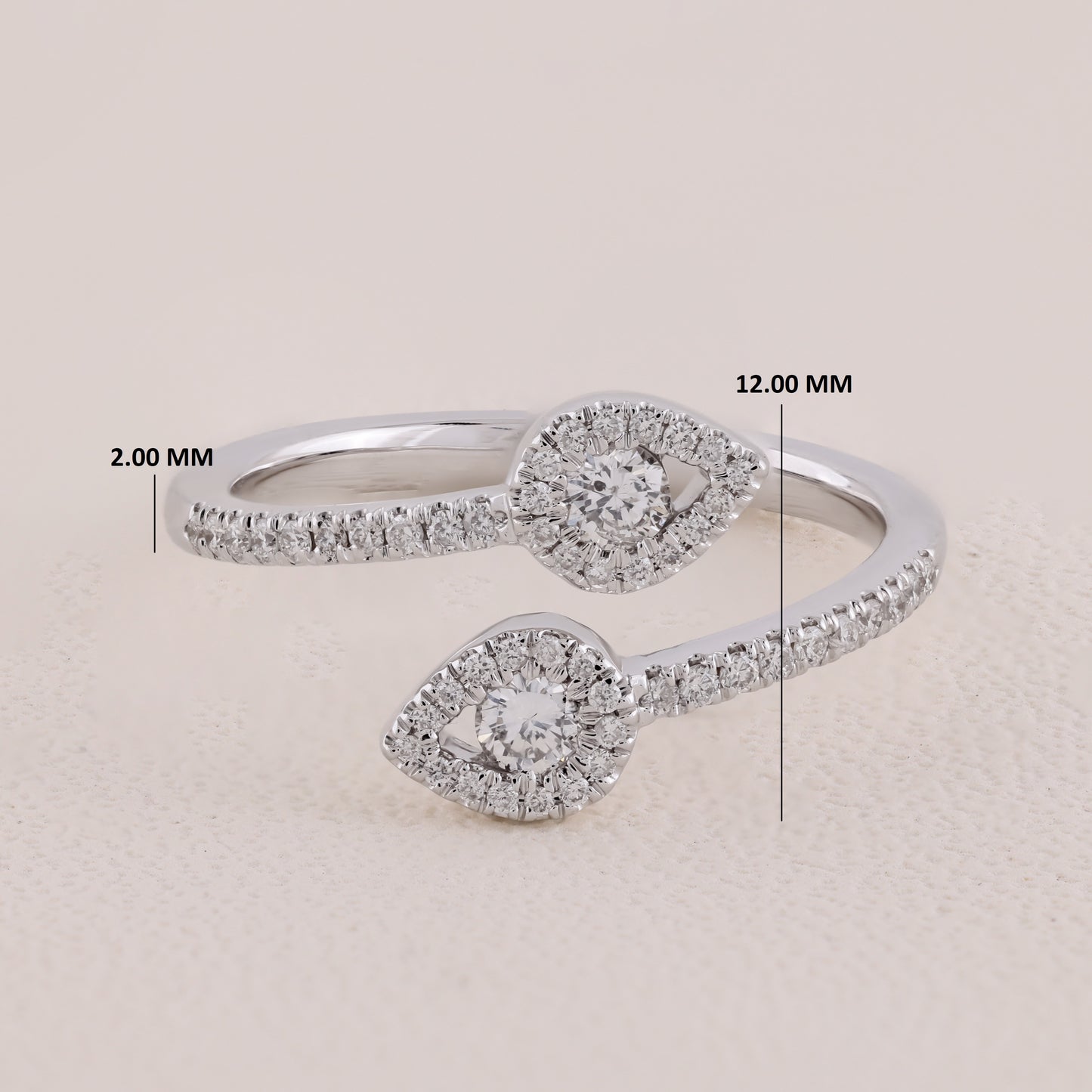 Silver ring with diamond accents and measurements on a beige background