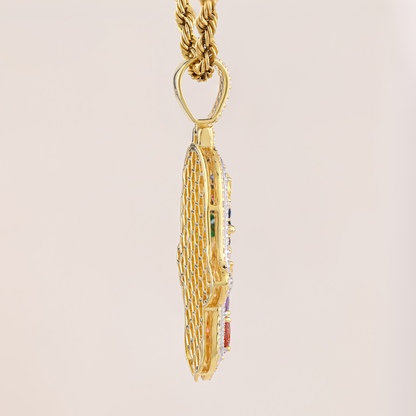 Gold necklace with a detailed pendant on a beige background