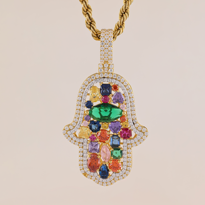 Jewelry pendant with colorful gemstones and gold chain on beige background