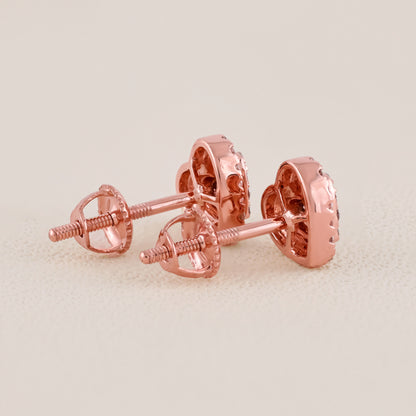 Rose gold earrings on a light beige background