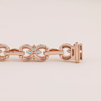 Rose gold bracelet with turquoise stones on a beige background