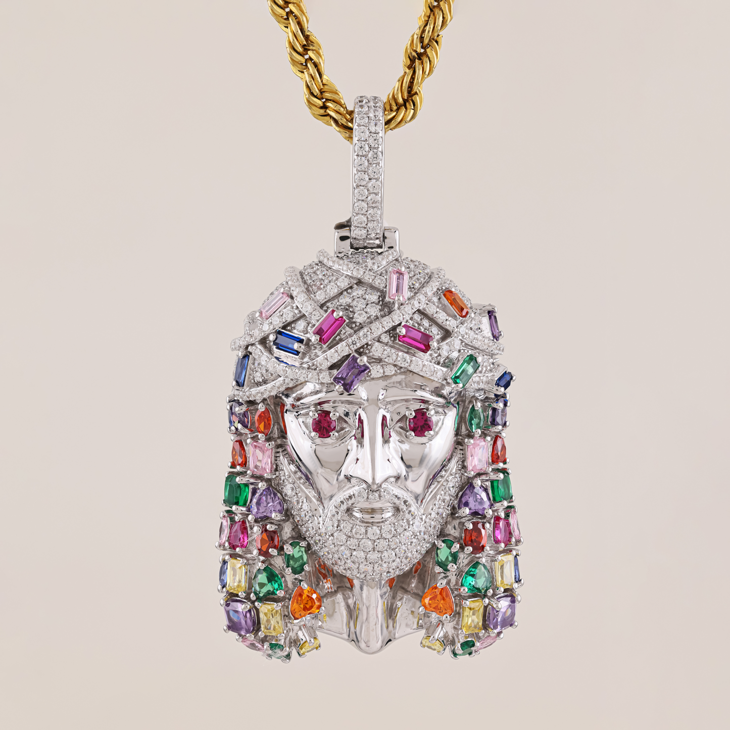 Luxury pendant with multicolored gemstones and gold chain on a beige background