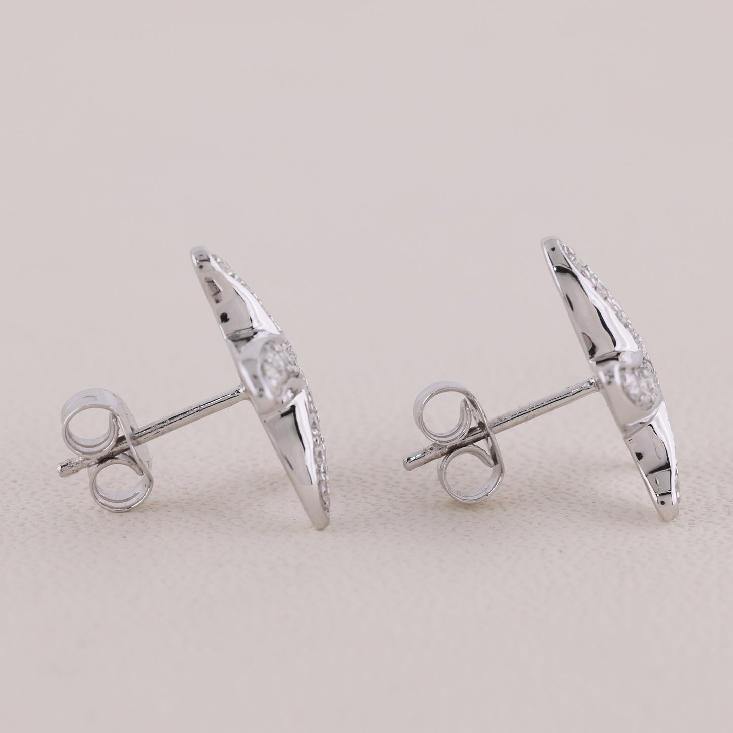 Pair of silver earrings on a light gray background