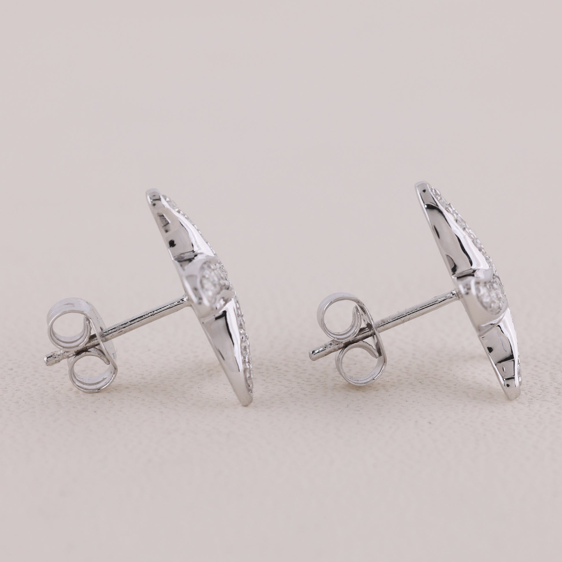 Pair of silver earrings on a light gray background