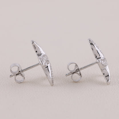 Pair of silver earrings on a light gray background