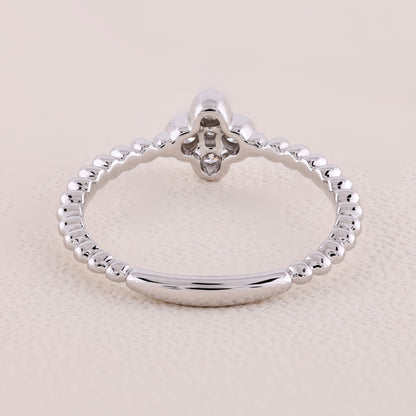 Silver ring with a diamond on a beige background