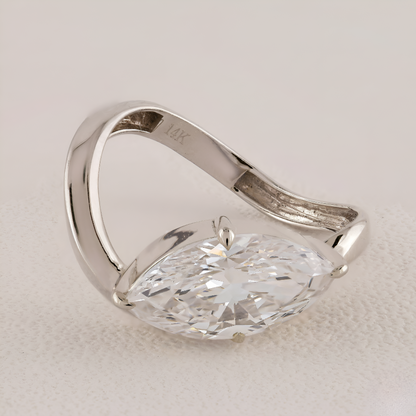 Silver ring with a large diamond on a light background
