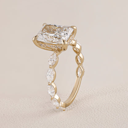Gold ring with a large diamond and smaller diamonds on a beige background