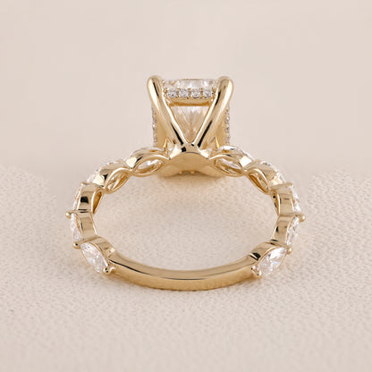Gold ring with diamond accents on a beige background