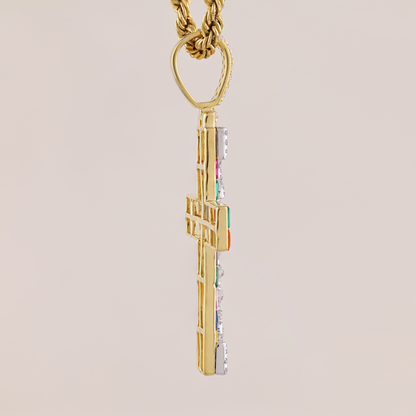 Gold cross pendant with colorful accents on a beige background