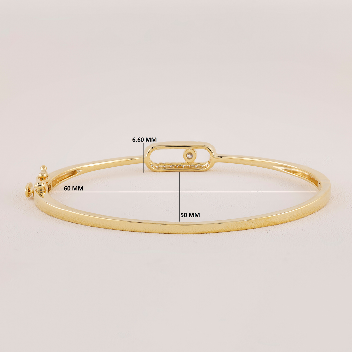 Gold bracelet with measurement details on a light gray background