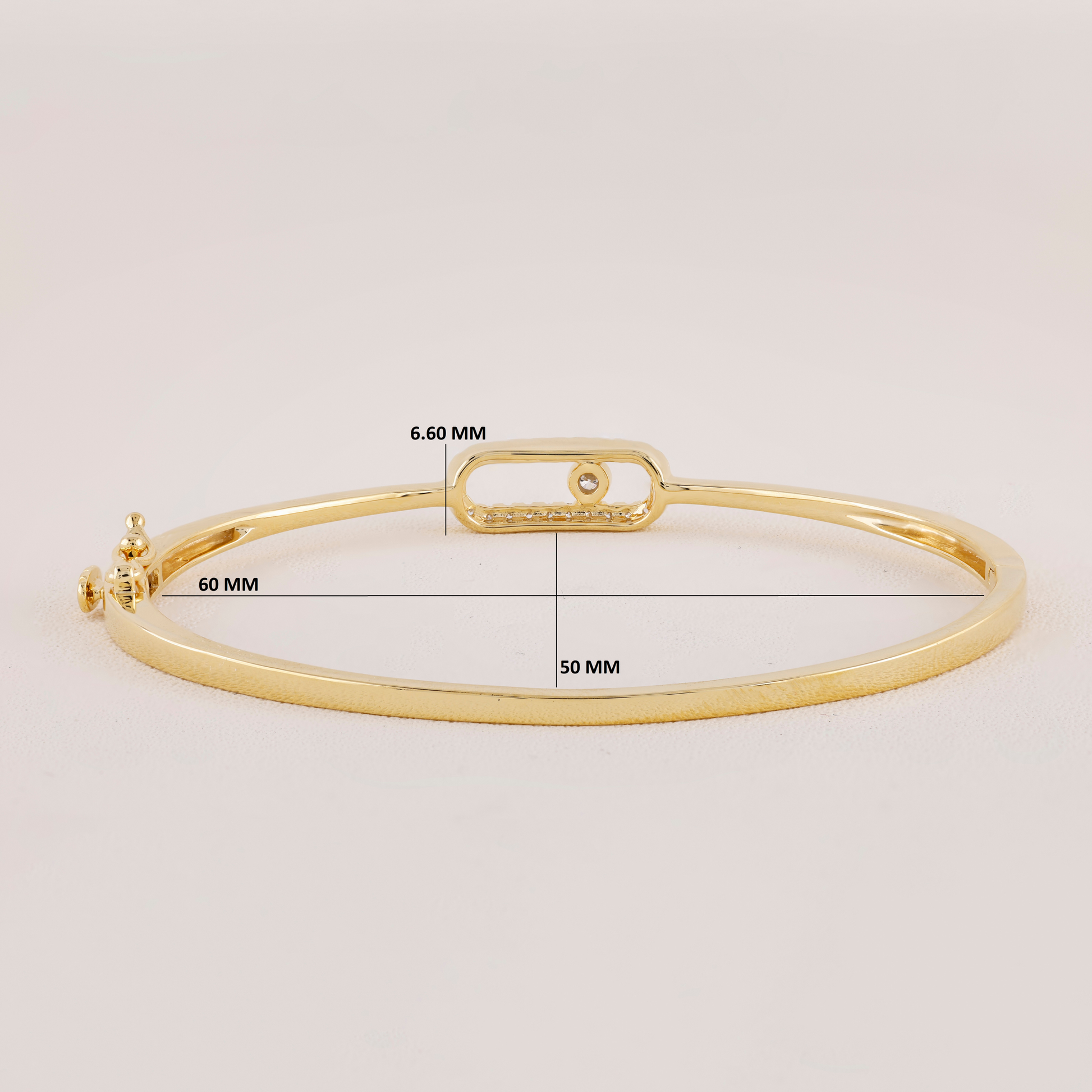 Gold bracelet with measurement details on a light gray background