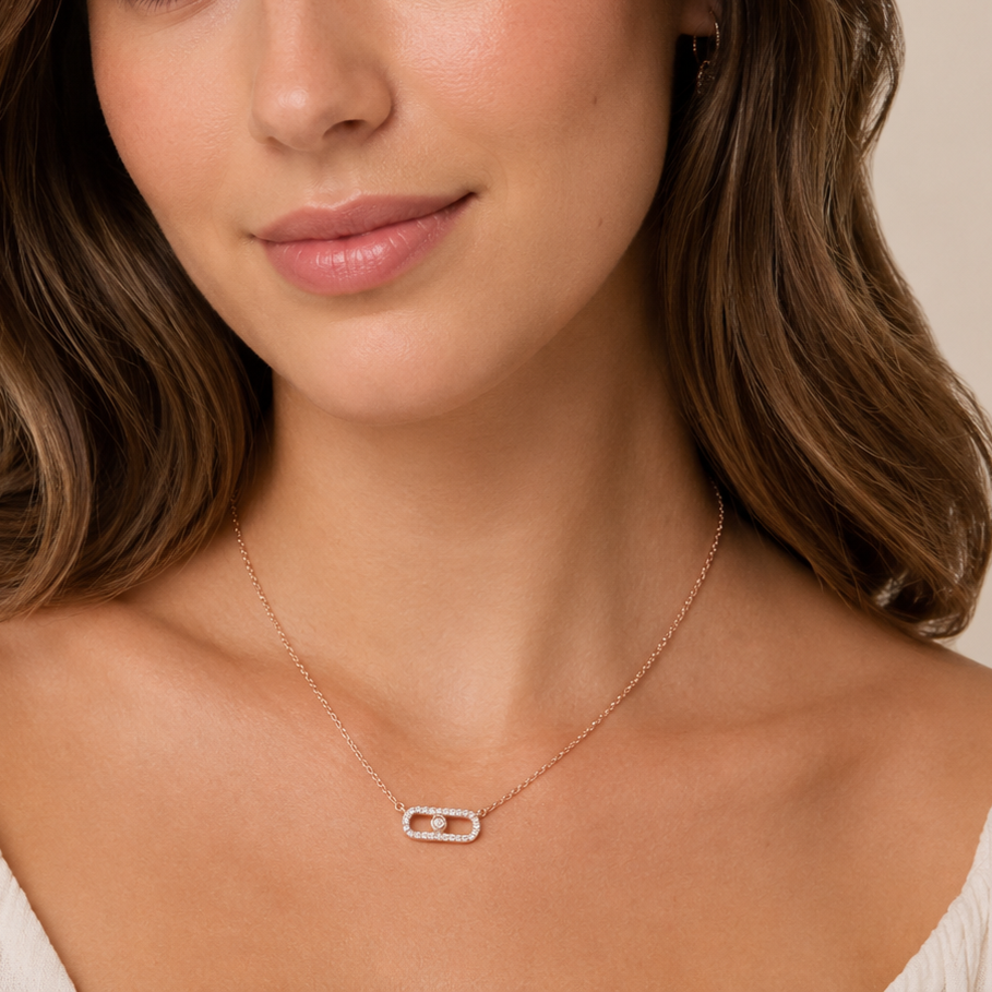 Close-up of a woman wearing a delicate necklace with a beige background