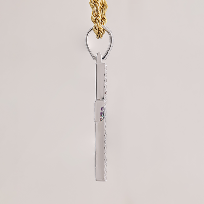 Silver pendant with a purple gemstone on a gold chain against a light gray background